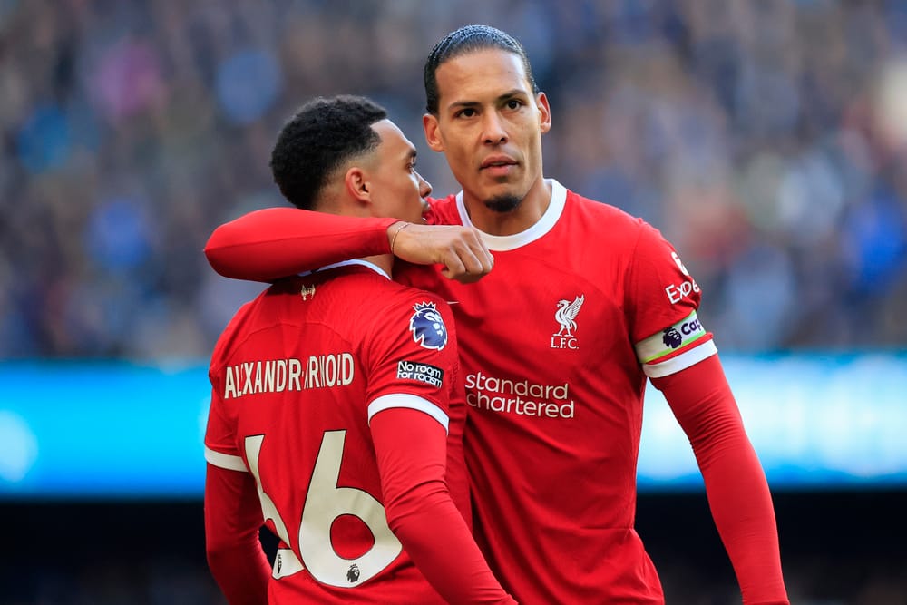 Liverpool celebrates with Virgil van Dijk #4.